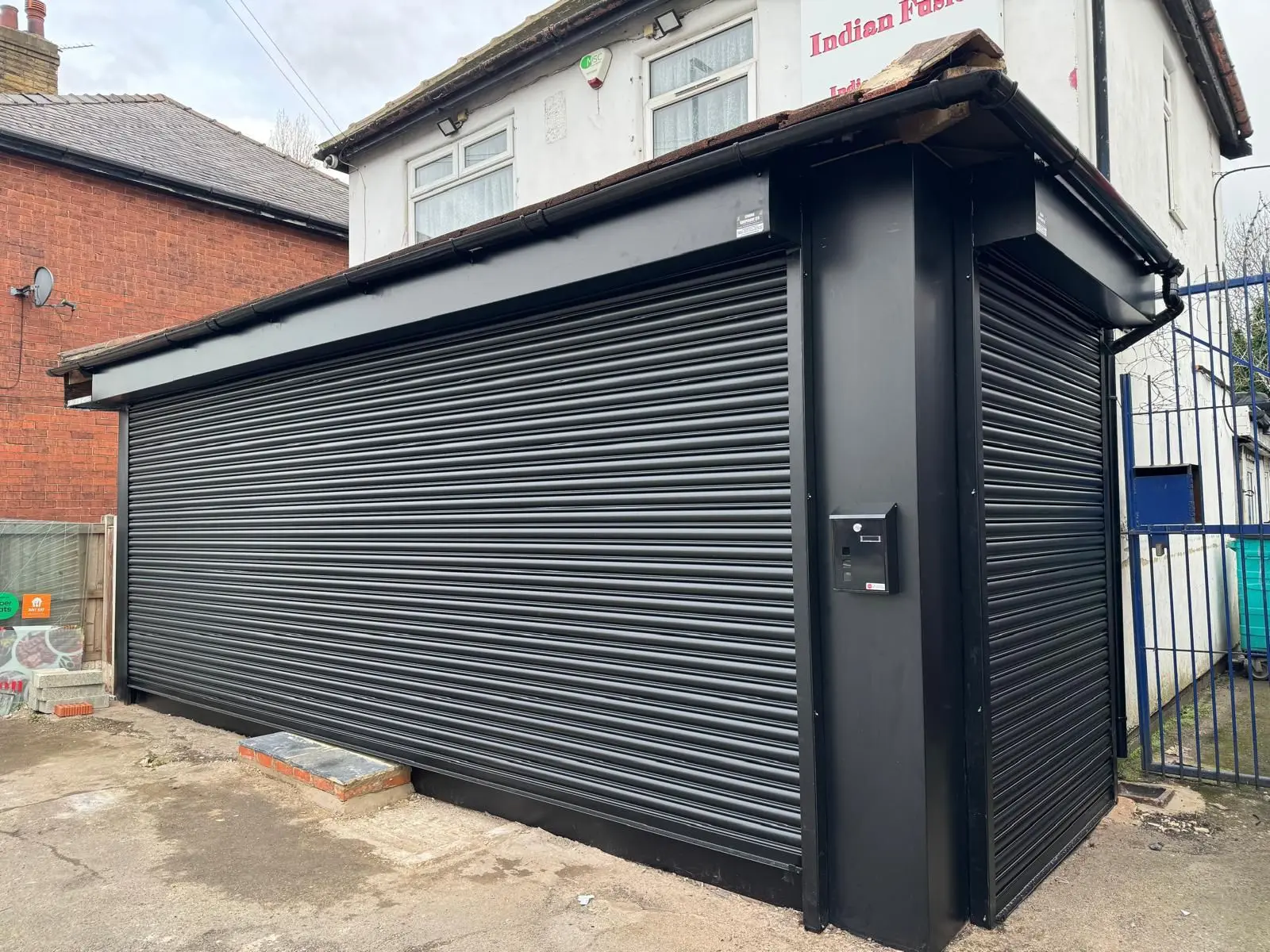 Completed black roller shutter installation